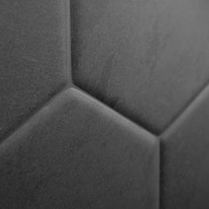 black and white photograph of an abstract hexagonal tile pattern on a wall or floor