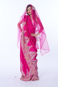 Photo of a woman wearing myObioma's Nafrican Pink Hijab Dress Pink Long Sleeve Dress With Dabka, Pink Zari Work Dress For Traditional Ceremonies, Pink Dresses With Resham Embroidery In Traditional Drape, Pink Dress With Resham Embroidery And Traditional Drape, Pink Dupatta With Dabka In Traditional Drape, Pink Saree Dress With Pallu, Traditional Pink Dupatta With Dabka Embroidery, Pink Dresses With Resham Embroidery For Traditional Ceremonies, Pink Dress With Sheer Dupatta For Festive Occasions