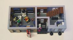 an overhead view of a lego model of a living room, kitchen and dining area