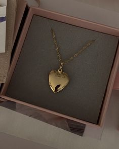 Product Description Featuring a beautiful heart locket pendant necklace that can store two photos for keepsake. This Valentine's limited edition piece is crafted in 18k gold fill, perfect as a long-lasting gift for the special someone. This is a limited edition item and will not be restocked once sold out. …………………………………. D E T A I L S • Charm measures 29.4 mm x 19.3 mm • Tarnish-resistant, waterproof, safe for sensitive skin • Comes with Singapore rope chain with a spring clasp • 100% 18K gold-f Gold Locket Necklace, Locket Pendant Necklace, Heart Locket Necklace, Heart Locket, Beautiful Heart, Locket Necklace, Rope Chain, Fashion Clothes, Gold Vermeil