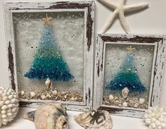 two framed pictures with sea shells and seashells in front of them, one is decorated as a christmas tree