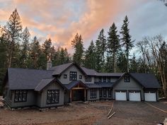 a large house sitting in the middle of a forest