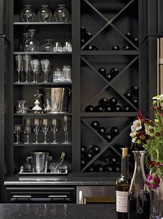 a wine rack filled with lots of bottles and glasses