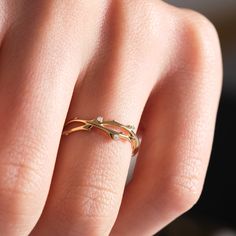 a woman's hand with a gold ring on it