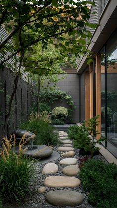 an outdoor garden with stepping stones and trees