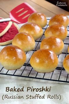 baked pirroskii russian stuffed rolls on a cooling rack next to watermelon slices