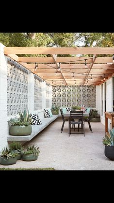 an outdoor patio with seating and potted plants