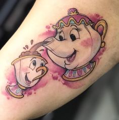 a watercolor tattoo with an image of beauty and the beast on it's arm