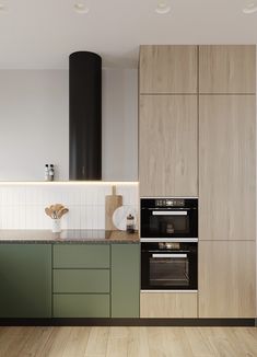 a modern kitchen with green cabinets and wood flooring on the walls, along with an oven