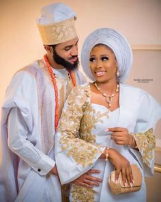 a man and woman dressed in traditional african clothing