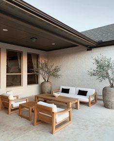 an outdoor living area with furniture and potted plants