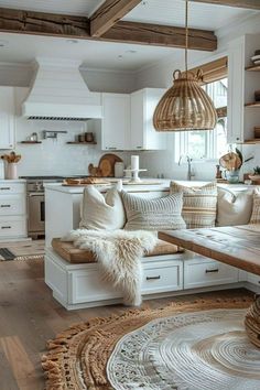 a living room filled with furniture and lots of pillows on top of a wooden floor