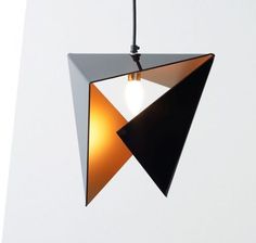 a black and white lamp hanging from a ceiling in the shape of an upside down triangle