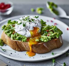 a white plate topped with bread covered in guacamole