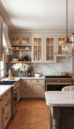 a kitchen filled with lots of counter top space and wooden flooring next to an island