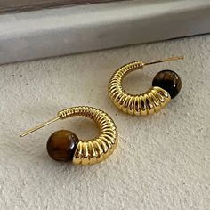 Material quality: metalTreatment process: electroplating Trendy Metal Earrings With Plating, Trendy Metal Plated Hoop Earrings, Brown Metal Hoop Jewelry, Geometric Hoop Earrings, Geometric Textures, Brown Stone, Stone Texture, Memorable Gifts, Hook Earrings