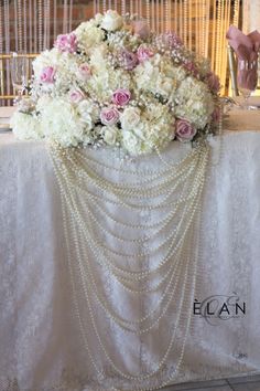 a table with flowers and pearls on it