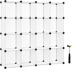 a white shelf with black dots and an object on it's side, in front of a white background