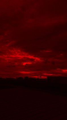 the sky is red and cloudy at night