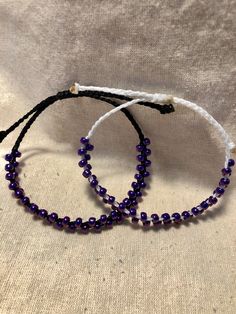 Purple seed beads braided onto black ans white waxed polyester cord with a square knot slide closure. Purple Beaded Bracelets, Halloween Bracelet, White Wax, Macrame Bracelets, Braided Bracelets