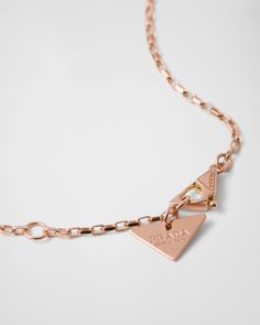 750 Pink Gold (18 kt) Triangle pendant: 1.3 cm (0.51 inches) Lobster claw clasp with logo-engraved medal Length: 45 cm (17.71 inches) adjustable to 43 cm (16.92 inches) and 41 cm (16.14 inches) Made in Italy Each step of Prada's responsible gold and diamond production chain is verified and traceable thanks to Aura Blockchain technology. Luxury Gold-tone Jewelry With Logo Charm, Formal Gold-tone Necklace With Logo Plaque, Classic Round Jewelry With Logo Charm, Classic White Gold Jewelry With Logo Charm, Gold-tone Jewelry With Logo Charm For Formal Occasions, Formal Gold Necklace With Gold-tone Logo Plaque, Gold-tone Logo Plaque Pendant Necklace, Classic Formal Jewelry With Gold-tone Logo Plaque, Gold-tone Logo Plaque Pendant Necklace As Gift