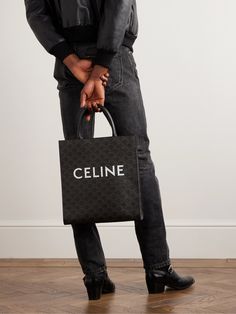 "CELINE HOMME's bold logo is one of the most recognisable in fashion, " we write in The Journal ; not least because it can turn simple accessories like this tote bag into a statement piece. Crafted from durable coated-canvas, it's patterned with the brand's 'Triomphe' monogram and has leather top handles. Messenger Bag Men Outfit, Celine Cabas, Dior Tote Bag, Tote Bag For Men, Men Dior, Simple Accessories, Bold Logo, Luxury Men, Messenger Bag Men