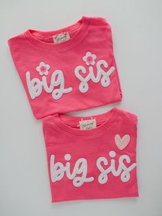 Ready To Ship big sister t-shirt! This listing is for one hot pink 'big sis' short-sleeve t-shirt. The text is created in white felt and hand-stitched with either two white flowers to dot the 'i' (as shown) or a blush pink heart above text (as shown). The shirt cannot be changed or customized. ----- - DETAILS - This listing is for one size 2T, short-sleeve, hot pink hand-embroidered 'big sis' t-shirt as shown. All items sold separately.  This t-shirt is ready to ship and cannot be customized. Re Pink Crew Neck Top With Embroidered Text, Pink Crew Neck T-shirt With Embroidered Text, Pink Short Sleeve Tops With Embroidered Text, Pink Embroidered Text Crew Neck T-shirt, Pink Long Sleeve T-shirt With Name Print, Baby Announcement Shirt, Big Sister T Shirt, Baby Announcement Shirts, Sibling Shirts