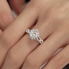 a woman's hand with a diamond ring on her finger and an engagement band