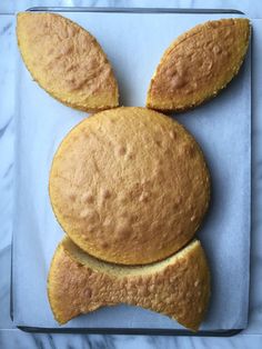 a bun with ears made out of bread sitting on top of a blue countertop