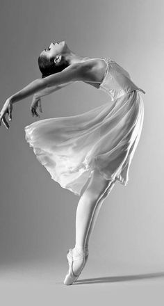 a black and white photo of a ballerina