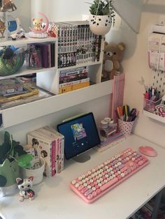 a desk with a keyboard, mouse and various other items on it in a room