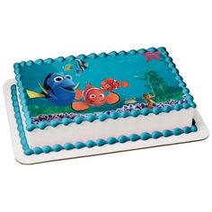 a blue and white cake with an image of finding dory on the side,