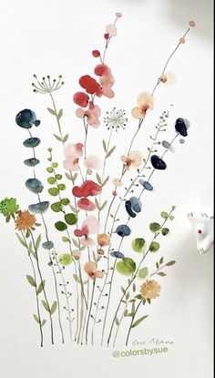 watercolor painting of colorful flowers on white paper