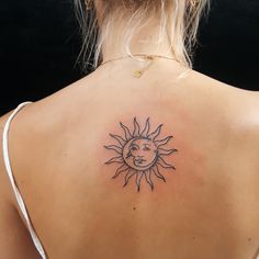 a woman with a sun tattoo on her back