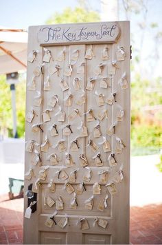 the wedding sign is made out of white paper and has hearts on it, as well as an arrow