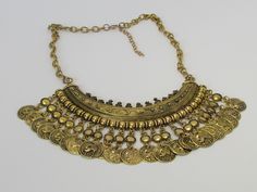 This Turkish Gold Coin Metallic Tribal Ethnic Chunky Bib Choker Statement Necklace is a jewelry made of gold alloy with vintage tribal tassel coin charms design. The choker bib is a perfect statement jewelry piece for women that will bring together and enhance any outfit. Laboutiquedacula offers a specialized customer service team that is available seven days a week to answer any product questions before, during or after the purchase. Find a special gift for a loved one or a beautiful piece that Statement Choker Necklace, Gold Alloys, Gold Coin, Seven Days, Gold Coins, Statement Jewelry, Jewelry Pieces, Special Gifts, Choker