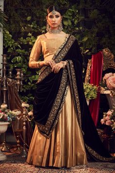 Oxidised gold lehenga with embroidered neckline and cuffs blouse. Paired with silk velvet floral embroidered black dupatta.
Component: 3
Embroidered
Neckine: Sqaure
Sleeve Length: Three quarter
Fabric: Silk Tissue, Silk Velvet
Color: Gold
Embroidered dupatta
Zardosi embroidery
Back tie-up - Aza Fashions Tissue Lehenga, Lehenga Anarkali, Velvet Dupatta, Blue Dupatta, Ridhi Mehra, Gold Lehenga, Anarkali Kurti, Blue Lehenga, Lehenga Collection