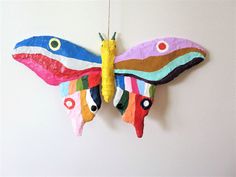 a colorful butterfly hanging on the wall