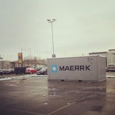 a large container sitting in the middle of a parking lot