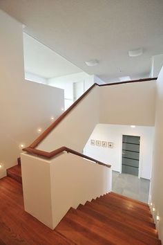 an empty room with stairs and lights on the wall