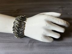 Beautiful silver tone bracelet in the style of Brutalist Mid Century jewelry. In good condition, has not been polished. Measures approximately 1 1/4" x 7 1/2" long Please review my description thoroughly and zoom into photos, as all sales are final. Feel free to convo if you have specific questions. All of my items are used/vintage pieces that have wear consistent with age. I always do our best to show and/or describe all of the vintage characteristics. Adjustable Oxidized Metal Chain Bracelet, Unique Metal Bracelet With Oxidized Finish, Adjustable Antique Silver Metal Cuff Bracelet, Adjustable Sterling Silver Oyster Bracelet, Silver Metal Cuff Bracelet, Jubilee Style, Adjustable Metal Chain Bracelet With Oyster Design, Nickel-free Antique Silver Metal Cuff Bracelet, Unique Sterling Silver Oyster Bracelet, Hand Cast Metal Bracelet Jewelry