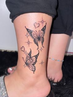 a woman's foot with butterfly tattoos on it