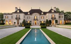 a large house with a pool in front of it