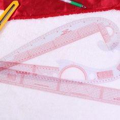 a pair of scissors, ruler and rulers on a white towel