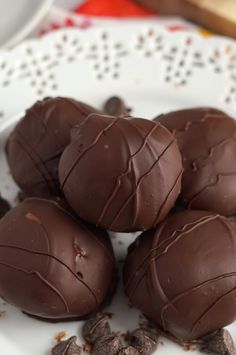 four chocolate eggs on a white plate