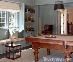 a pool table in the middle of a living room