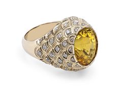 A bezel set oval cut yellow sapphire ring set with round brilliant diamonds in 18K yellow gold. The Gemological Institute of America (GIA) describes this sapphire as Natural with no indications of heating. Metal: 18K Yellow Gold Gemstone: Sapphire: 13.56 carats, GIA Report #2171344178 Yellow Sapphire Ring, Mens Gemstone Rings, Yellow Sapphire Rings, Yellow Sapphire, Brilliant Diamond, Bezel Setting, Oval Cut, Round Brilliant, Ring Set