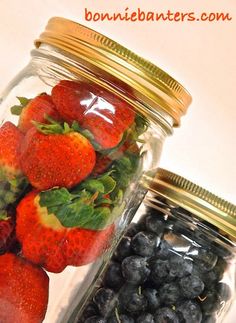 strawberries, blueberries and raspberries in a glass jar