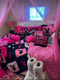 a bedroom with pink and black bedding, white curtains and shoes on the floor