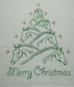 a cross stitch christmas tree with three horses on it's side and the words merry christmas written in green